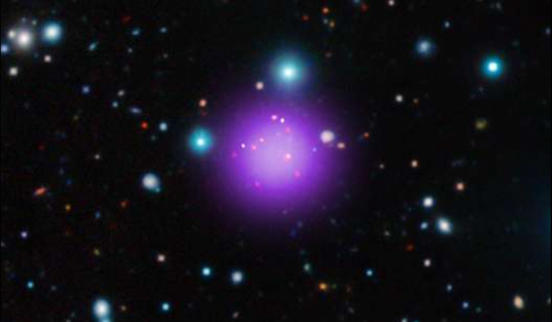 Galaxy cluster CL J1001+0220 is the most distant cluster ever discovered. This image is a composite of X-ray, infrared and radio observations from several telescopes. Credit: X-ray: NASA/CXC/CEA/T. Wang et al; Infrared: ESO/UltraVISTA; Radio: ESO/NAOJ/NRA