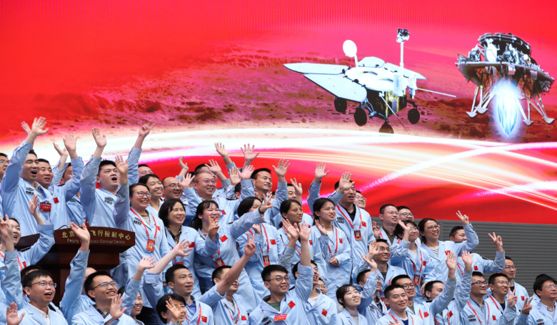 China's space programme team members celebrate on Saturday at the Beijing Aerospace Control Center after the successful landing of China's Tianwen 1 Mars probe on the Red Planet was announced. Image: Jin Liwang/Xinhua]