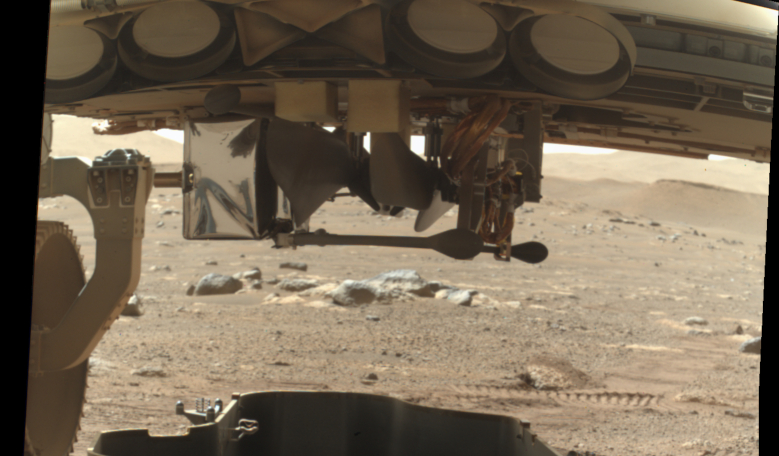 NASA's Perseverance rover just released the debris shield that protected the Mars helicopter during landing, giving the first glimpse of a rotorcraft on another planet. Image: NASA