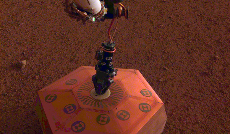 NASA's InSight lander placing its first instrument, the Seismic Experiment for Interior Structure, on Mars This was the first time a seismometer had ever been placed onto the surface of another planet. Image: NASA/JPL-Caltech