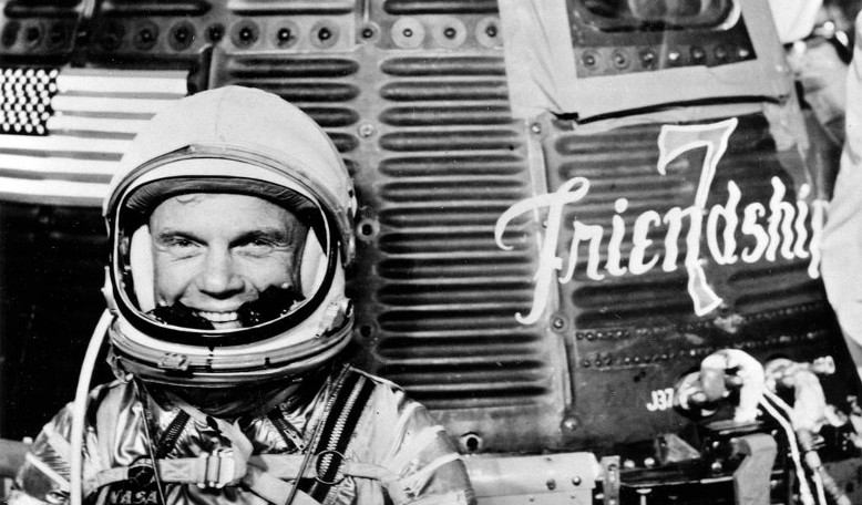 Astronaut John Herschel Glenn Jr, pilot of the Mercury Atlas 6 (MA-6) spaceflight, poses for a photo with the Mercury 