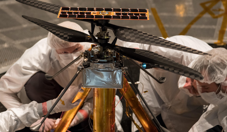 Members of the NASA Mars Helicopter team inspect the flight model (the actual vehicle going to the Red Planet), inside the Space Simulator, a 7.62-metre-wide vacuum chamber at NASA's JPL facility. Image: NASA