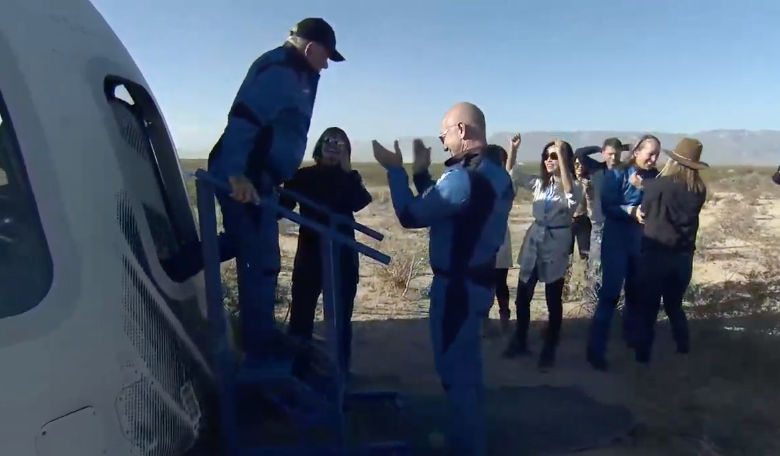 William Shatner emerges from New Shephard's crew capsule after a successful launch to the edge of space. Fellow crew member Audrey Powers is seen in the background.