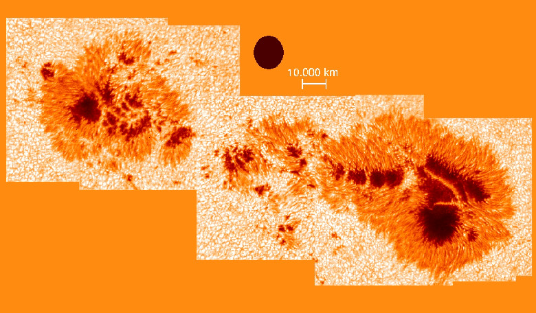 A large sunspot group observed with the Vacuum Tower Telescope (VTT) at the Teide Observatory. Note the light bridges crossing the dark centers (umbrae). The black circle corresponds to the size of the Earth. Image: KIS/VTT