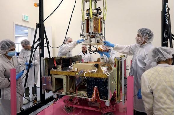 A deployable solar panel and power transmitter structure is lowered over the main body of Caltech s Space Solar Power Demonstrator