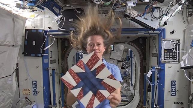 Demonstrating the use of a quilting block while on board the Space Station.