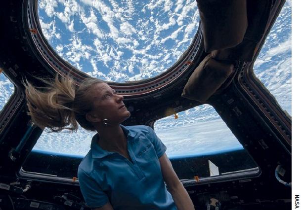 Karen Nyberg looks out of the Cupola on the ISS.